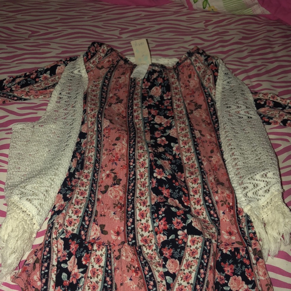 a flowy long sleeve shirt with a white cardigan